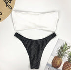 Detail close-up of black bikini set showcasing off-shoulder design, highlighting chic summer fashion.