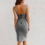 Back view of the denim suspender dress featuring button detail and adjustable straps in black and gray shades.