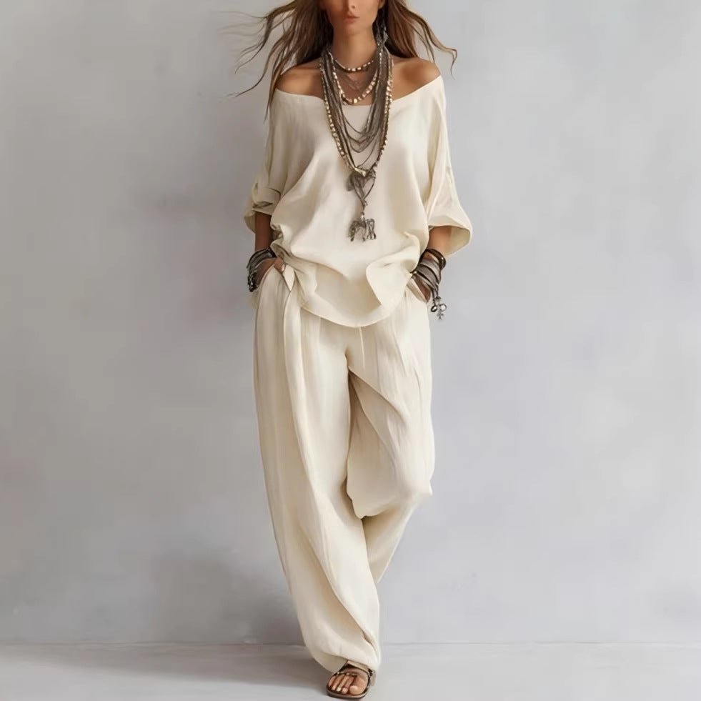Chic cream off-shoulder outfit with three-quarter sleeves and wide-leg pants, styled for casual occasions.