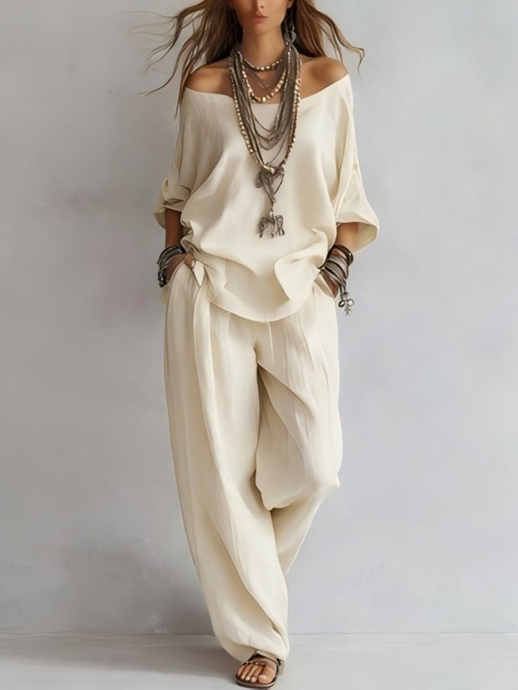 Stylish cream off-shoulder set highlighting three-quarter sleeves and wide-leg pants, ideal for a chic capsule wardrobe.