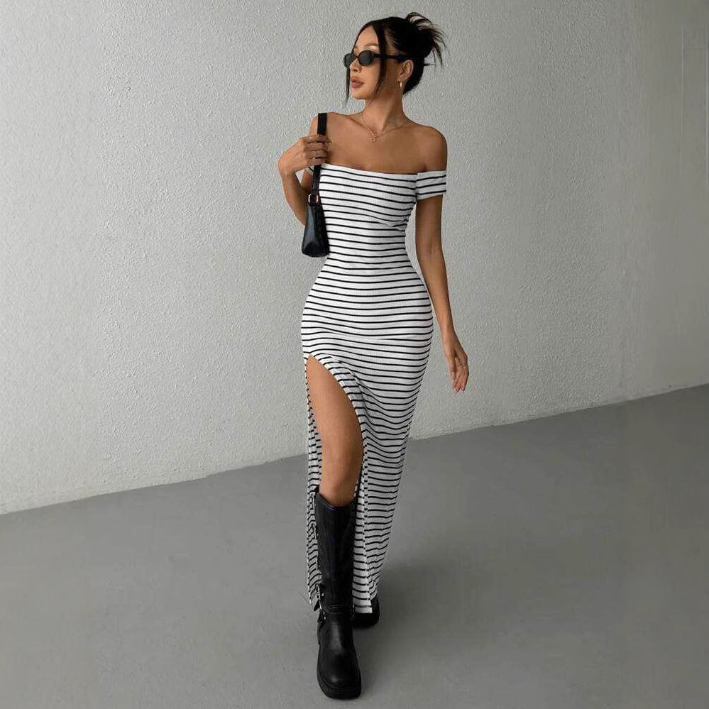 Lifestyle shot of a chic off-shoulder striped dress in black and white, featuring a slit design.