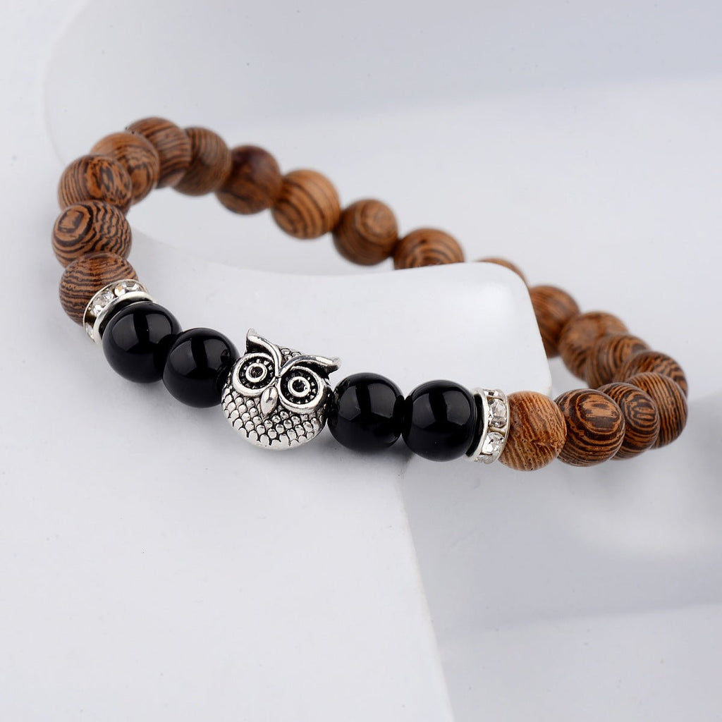 Detail close-up of the exotic wood grain bracelet with black alloy stone accents, showcasing its minimalist appeal.