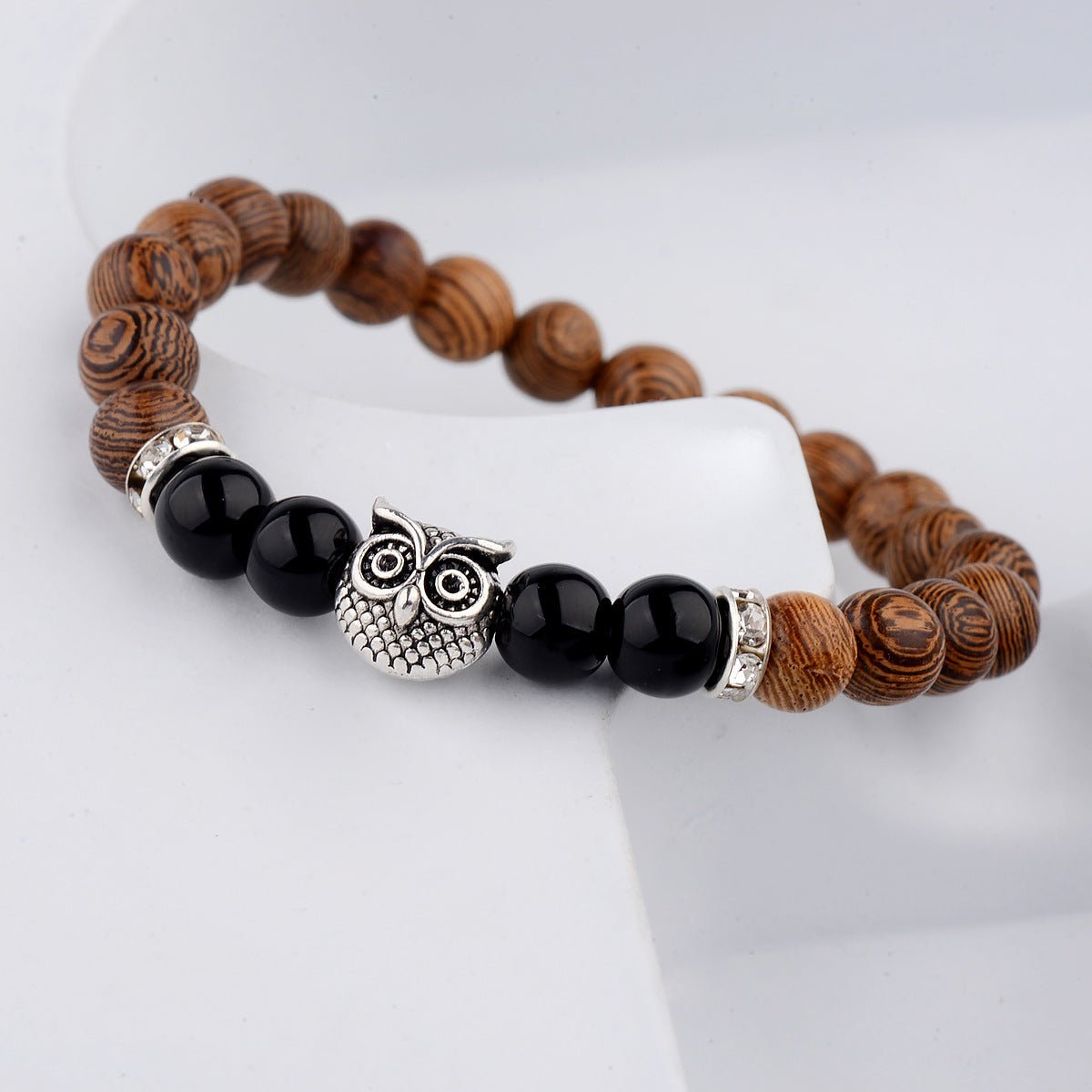 Detail close-up of the exotic wood grain bracelet with black alloy stone accents, showcasing its minimalist appeal.