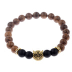 Detail close-up of the exotic wood grain bracelet featuring gold alloy stone accents, highlighting elegant craftsmanship.