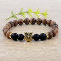 Detail close-up of the exotic wood grain bracelet featuring gold alloy stone accents on a natural background, showcasing e…