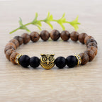 Detail close-up of the exotic wood grain bracelet featuring gold alloy stone accents on a natural background, showcasing e…