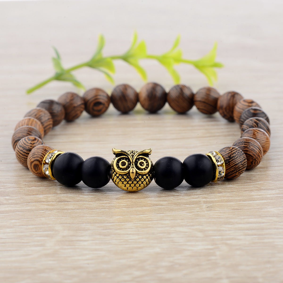 Detail close-up of the exotic wood grain bracelet featuring gold alloy stone accents on a natural background, showcasing e…
