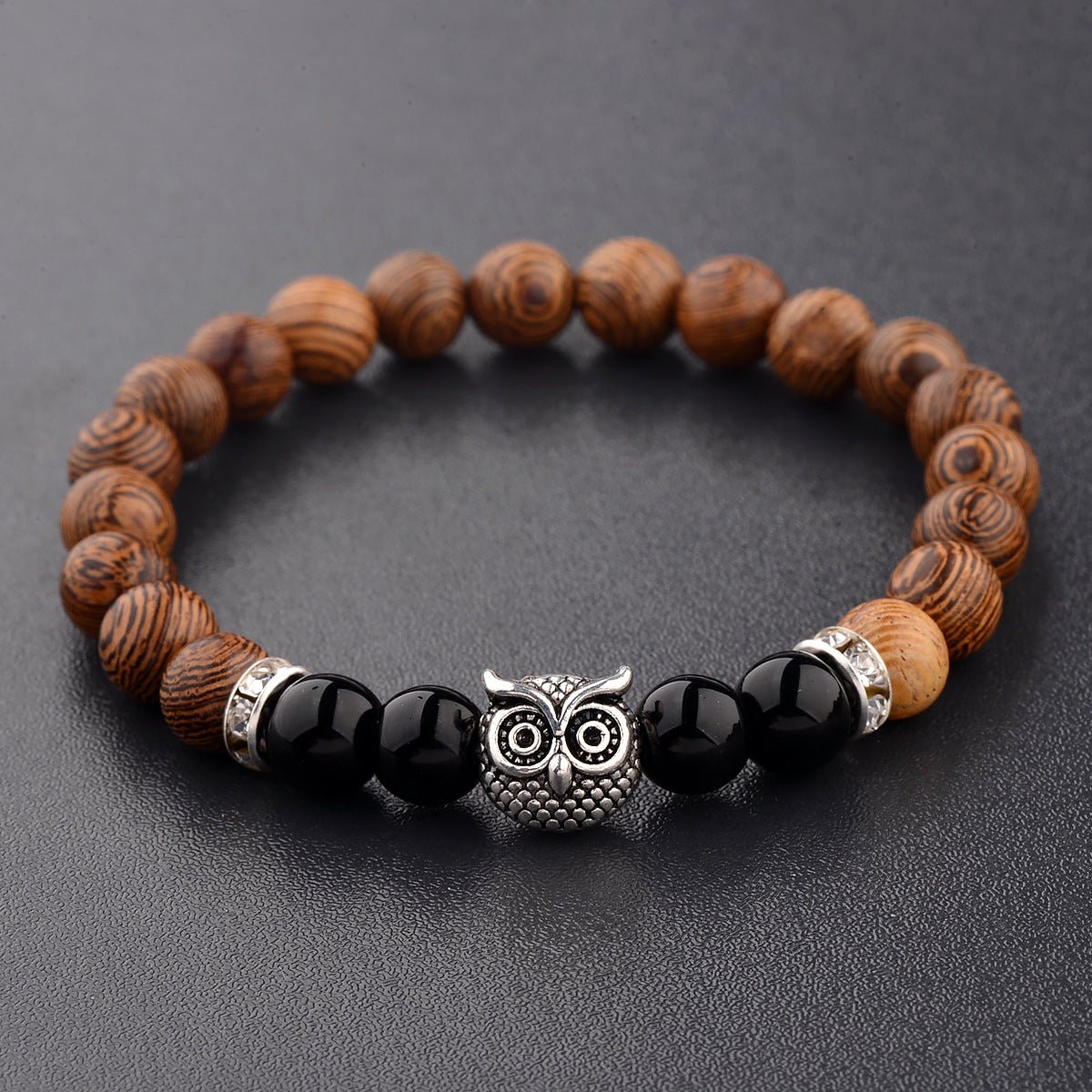 Detail close-up of the exotic wood grain bracelet with silver alloy stone accents, emphasizing its unique style.