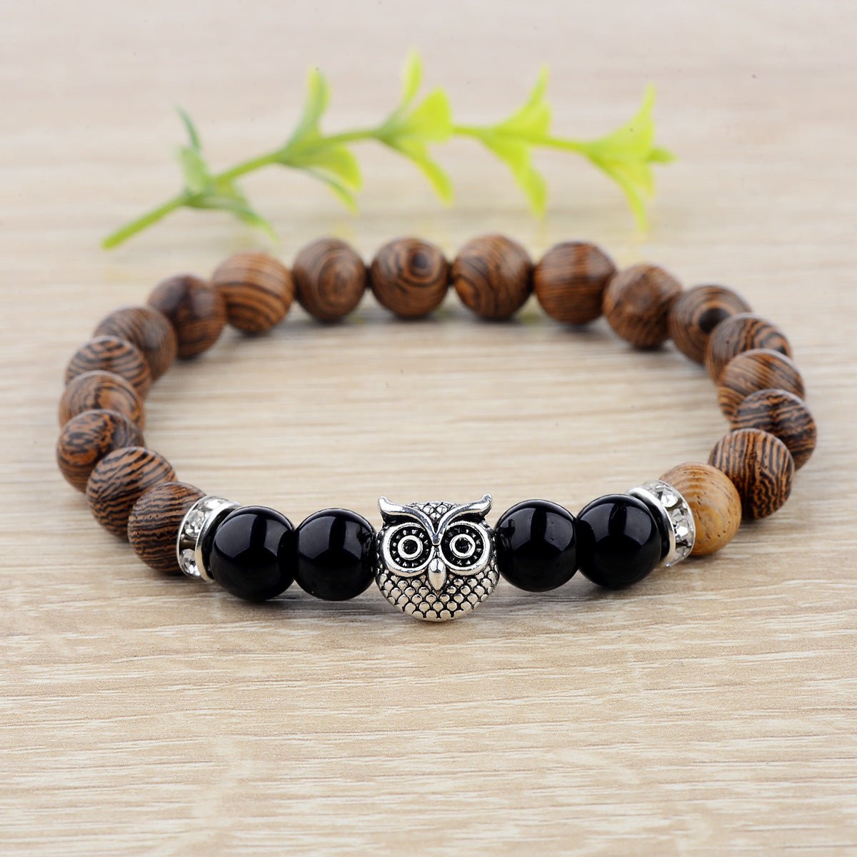 Detail close-up of the exotic wood grain bracelet with silver alloy stone accents on a natural background, highlighting it…