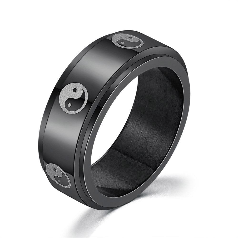 Detail close-up of a black titanium ring with a simple design and decorative elements.