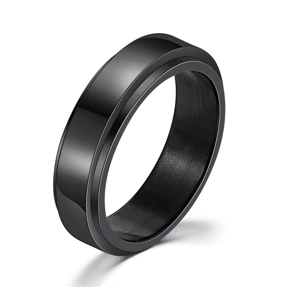 Detail close-up of a matte black titanium steel ring with a simple design.