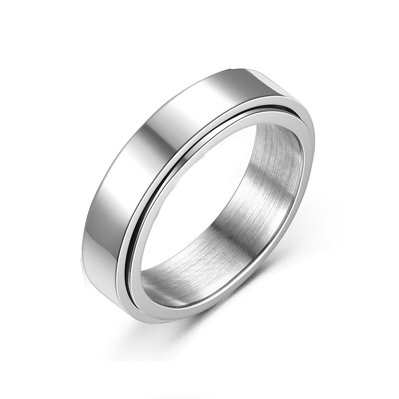 Detail close-up of a smooth silver titanium steel ring on a white background.