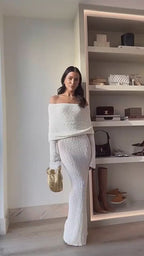 Lifestyle video of white one-shoulder dress with off-shoulder and wide leg features, showcasing elegant movement.
