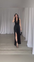 Lifestyle video of a woman in a white dress featuring a slit design, elegant and sophisticated.