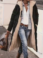 Video showcasing the black and beige hooded long coat, emphasizing its long length and chic design in a lifestyle setting.