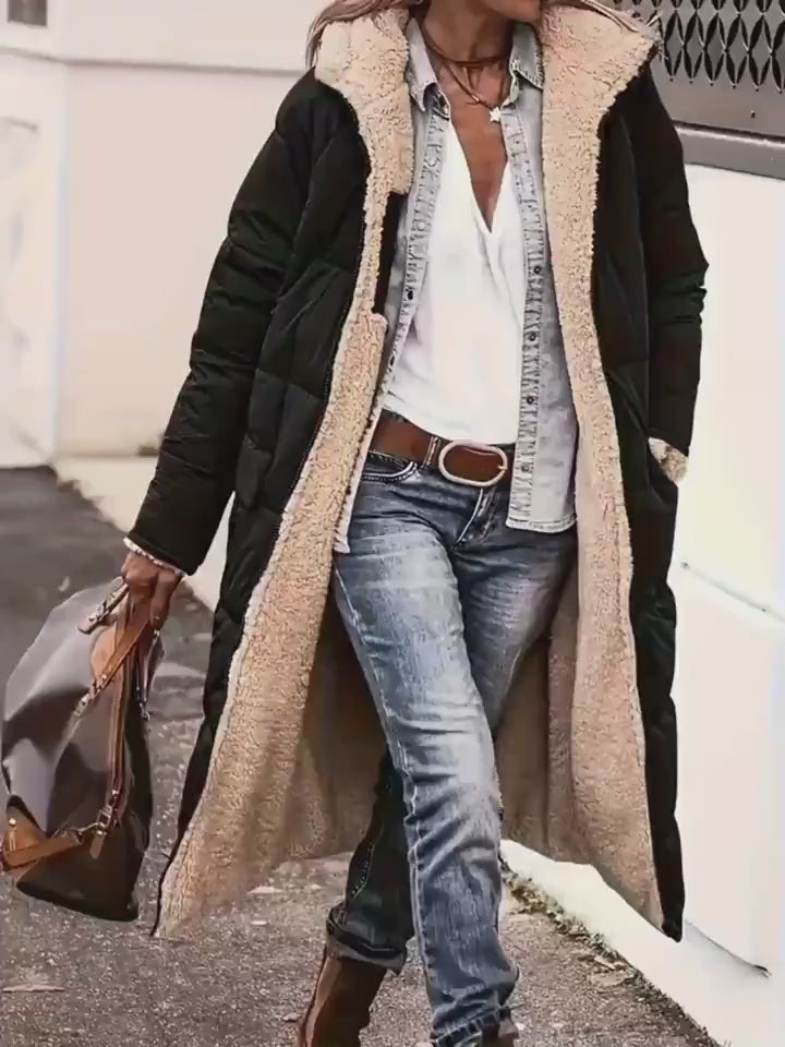 Video showcasing the black and beige hooded long coat, emphasizing its long length and chic design in a lifestyle setting.