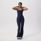 Lifestyle shot of a woman in a chic sleeveless flared leg jumpsuit, exuding minimalist elegance.