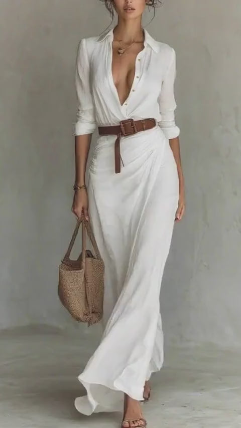 Lifestyle shot of a chic white dress with a belted waist and long sleeves, perfect for minimalist fashion.