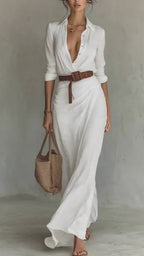 Lifestyle shot of a chic white dress with a belted waist and long sleeves, perfect for minimalist fashion.