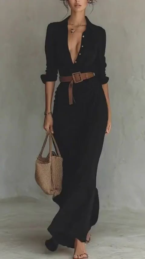 Lifestyle shot of a black dress with a belted waist and long sleeves, embodying elegant minimalist fashion.