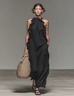 Video showcasing the black maxi dress with ruffled neckline, highlighting its flowy fabric and elegant style.