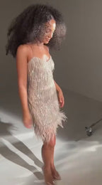 Lifestyle video showcasing a sparkly strapless dress in a studio background.