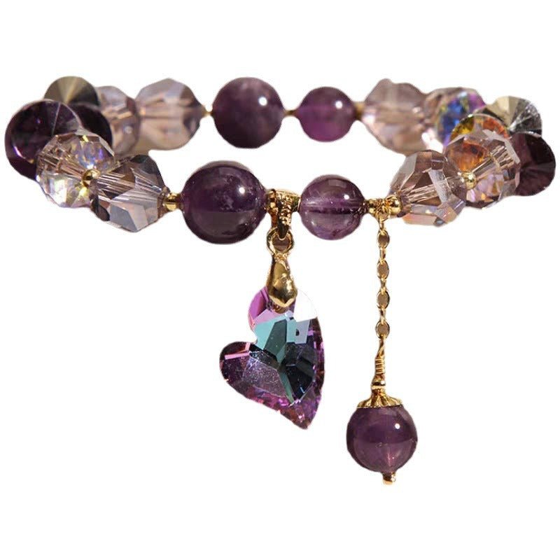 Close-up of the purple natural amethyst heart bracelet featuring heart charm and clear beads.