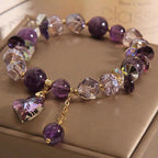 Detail close-up of the purple natural amethyst heart bracelet highlighting gold accents.