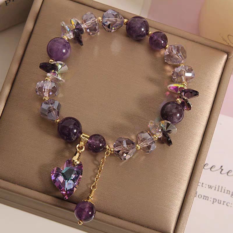 Close-up of the purple natural amethyst heart bracelet with heart charm and gold accents.