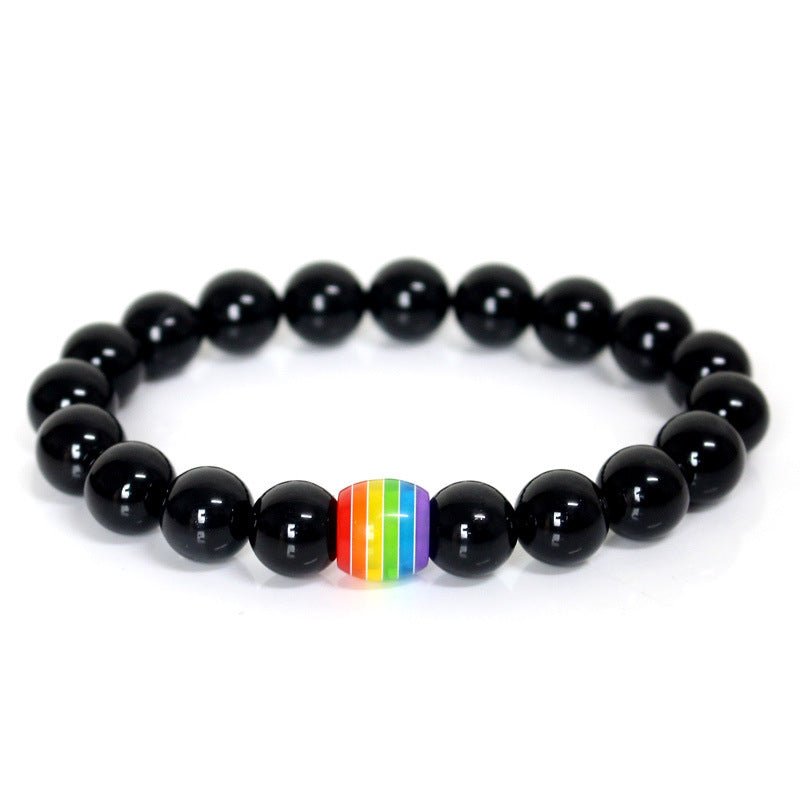 Detail close-up of the black rainbow bead bracelet with elastic band, showcasing its vibrant design on a white background