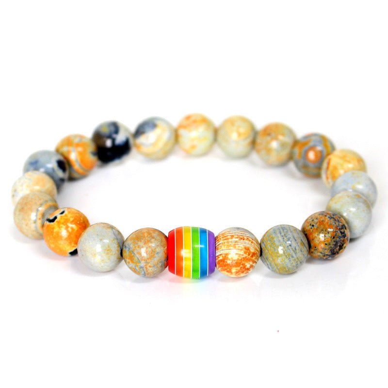 Detail close-up of the orange and brown rainbow bead bracelet with natural stones, featuring a chic design.