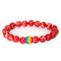 Detail close-up of the red rainbow bead bracelet with elastic band, highlighting its colorful design on a white background