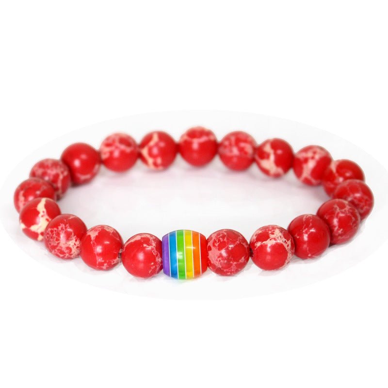 Detail close-up of the red rainbow bead bracelet with elastic band, highlighting its colorful design on a white background