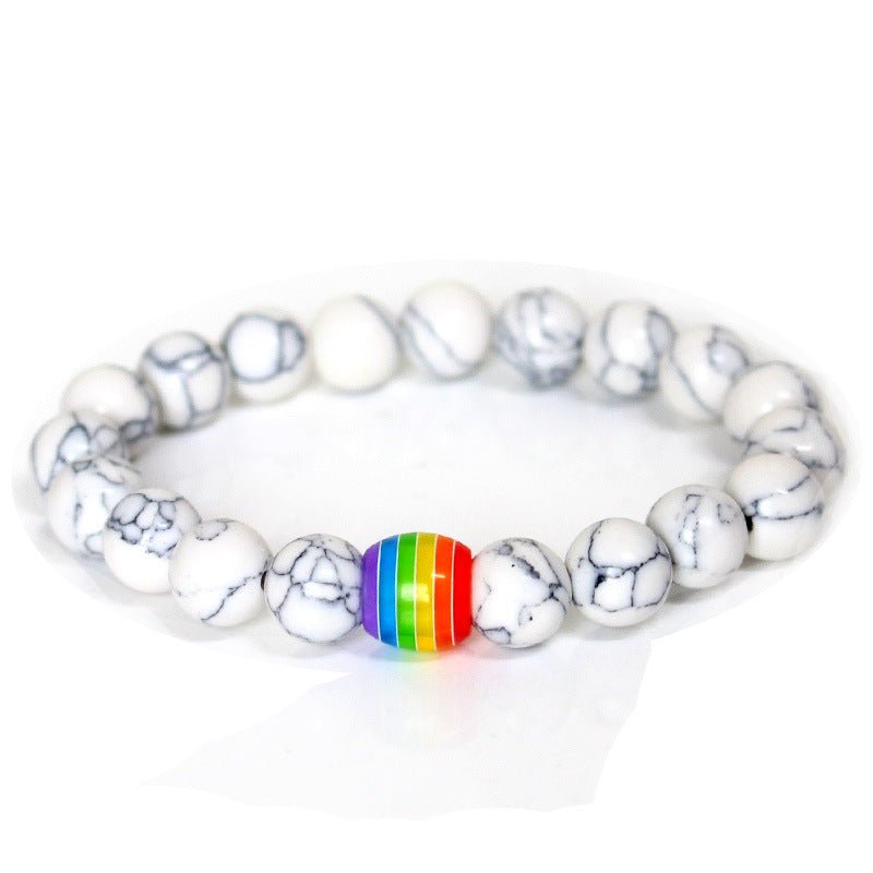 Detail close-up of the white rainbow bead bracelet displaying its elegant colors on a white background