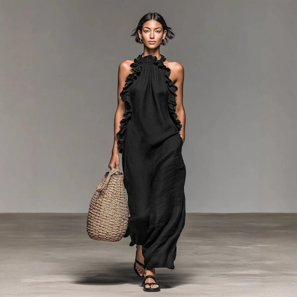 Long black ice silk crepe maxi dress with ruffled halter neck in lifestyle shot, showcasing chic fashion.