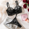 Packaging view of black mesh bra set, showcasing ruffled straps and elegant two-piece design