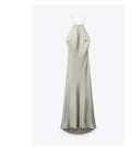 Front view of the light green satin sling dress, showcasing its silk texture and long length in a minimalist style.