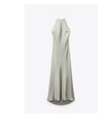 Front view of the light green satin sling dress, showcasing its silk texture and long length in a minimalist style.
