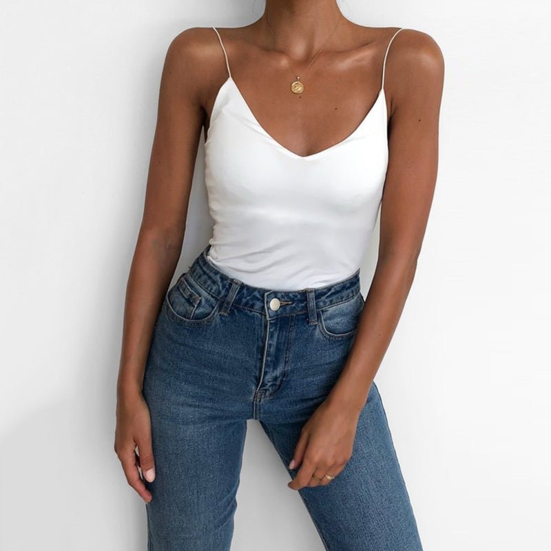 Lifestyle shot of a white satin camisole top with thin straps and v-neckline, chic minimalist style.