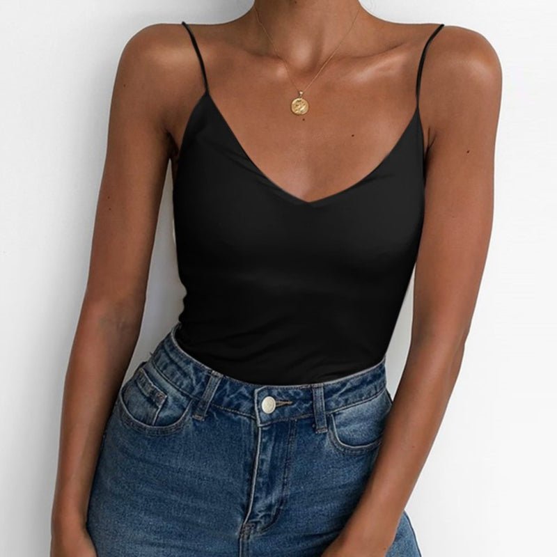 Lifestyle view of a fitted black satin camisole top with thin straps and v-neckline, sophisticated minimalist style.