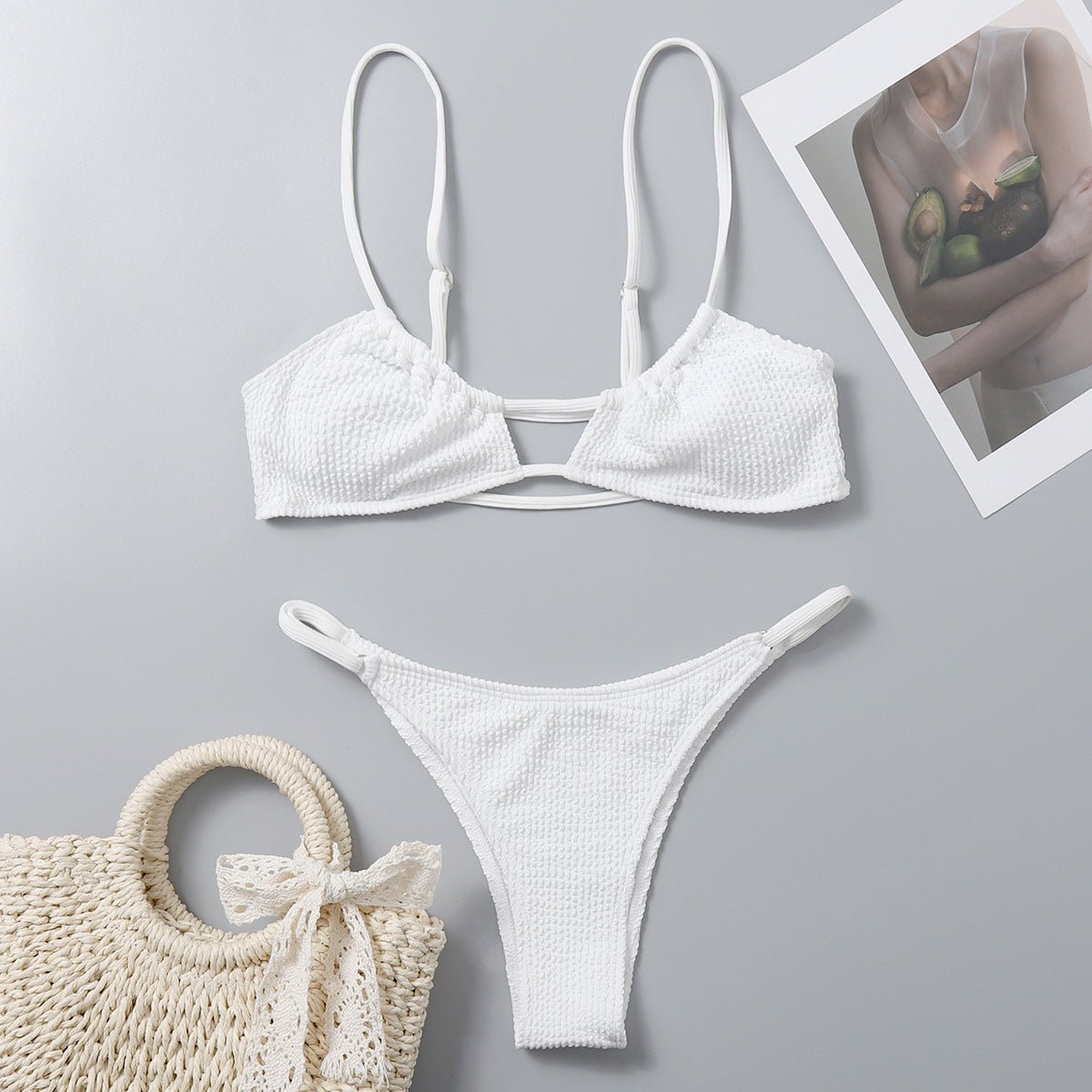 Packaging view of a white bikini set featuring adjustable straps and padded cups, presented elegantly.