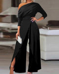 Lifestyle shot of a black long-sleeve jumpsuit, showcasing its sleek design and open-back detail.