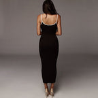 Side view of the white midi dress with contrast straps, highlighting its slim fit and elegant silhouette