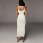Back view of the black and white midi dress with contrast straps, showcasing its elegant design and slim fit