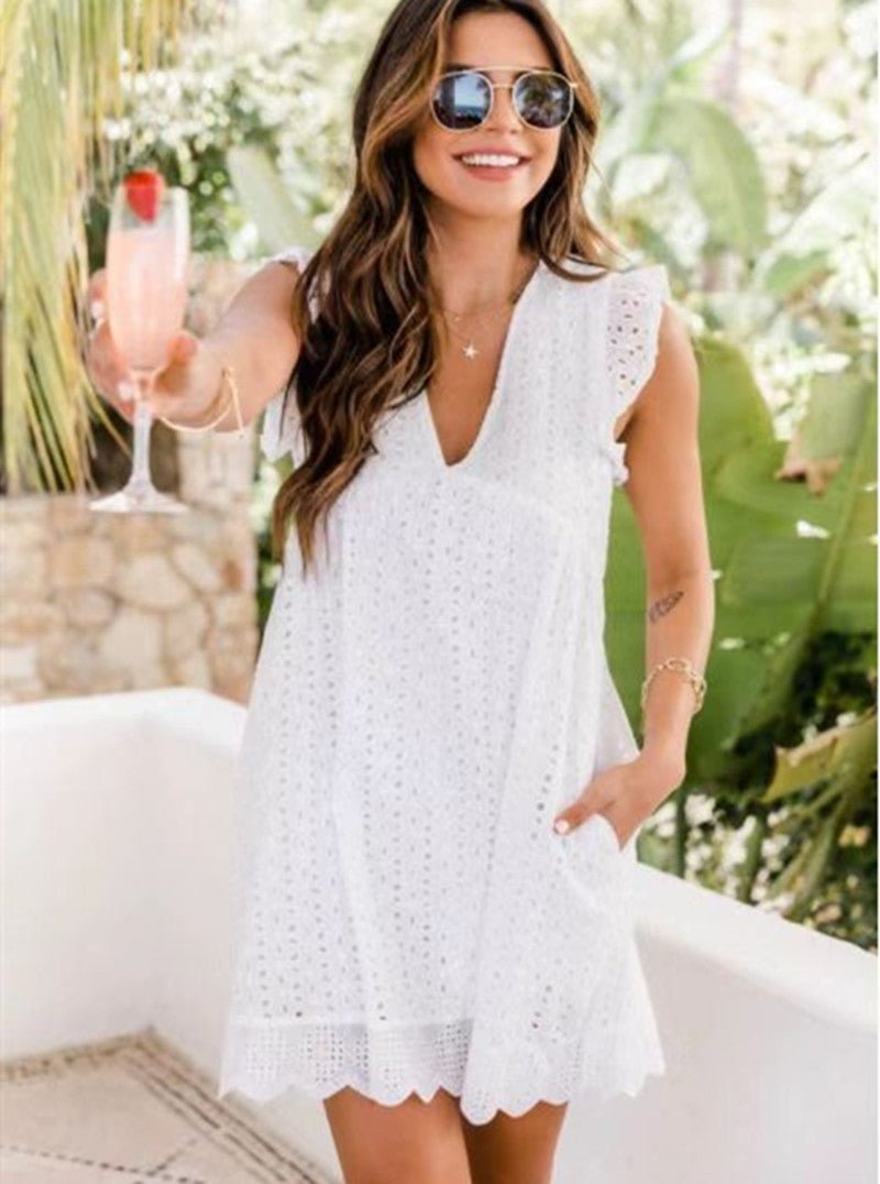 Lifestyle shot of a white sleeveless lace dress with V-neck and side pocket, perfect for summer outings.