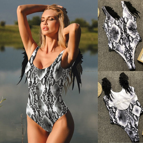 Lifestyle shot of a black and white snake print swimsuit bodysuit, showcasing a deep V-neck and chic minimalist style.