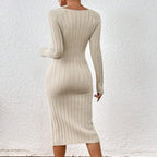 Back view of a beige knitted dress with long sleeves and a square collar, emphasizing a form-fitting silhouette.