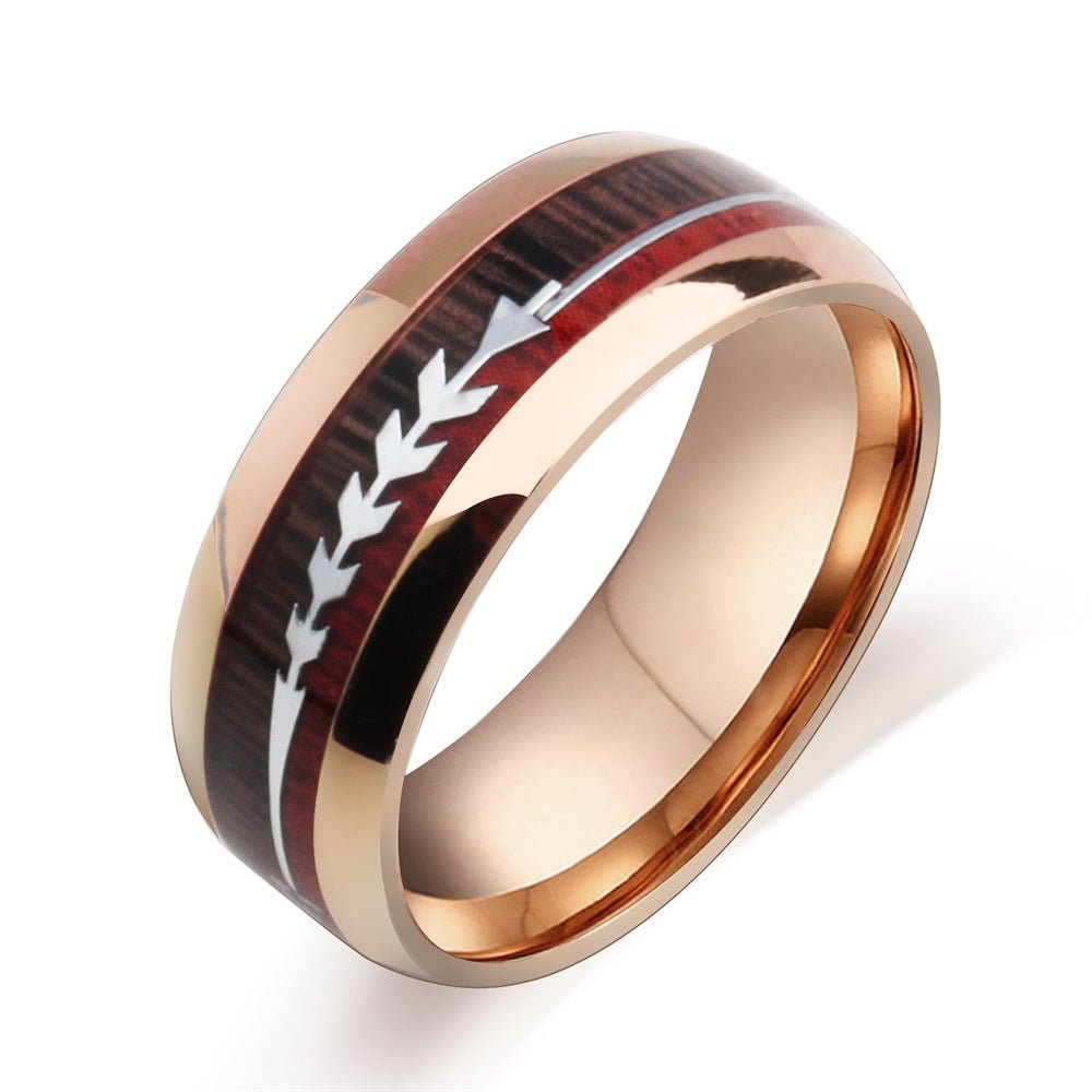 Men's stainless steel rings featuring arrow inlay in black and rose gold, detail close-up.