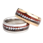 Men's stainless steel ring showcasing textured surface and arrow inlay in black and silver, detail close-up.