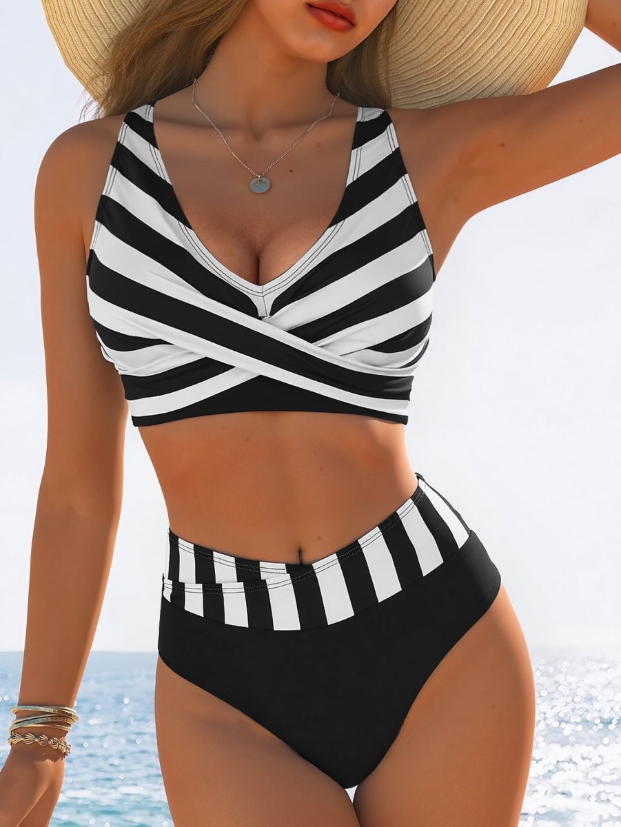 Lifestyle shot of a sexy black and white striped high-waist bikini with cross-over detailing.